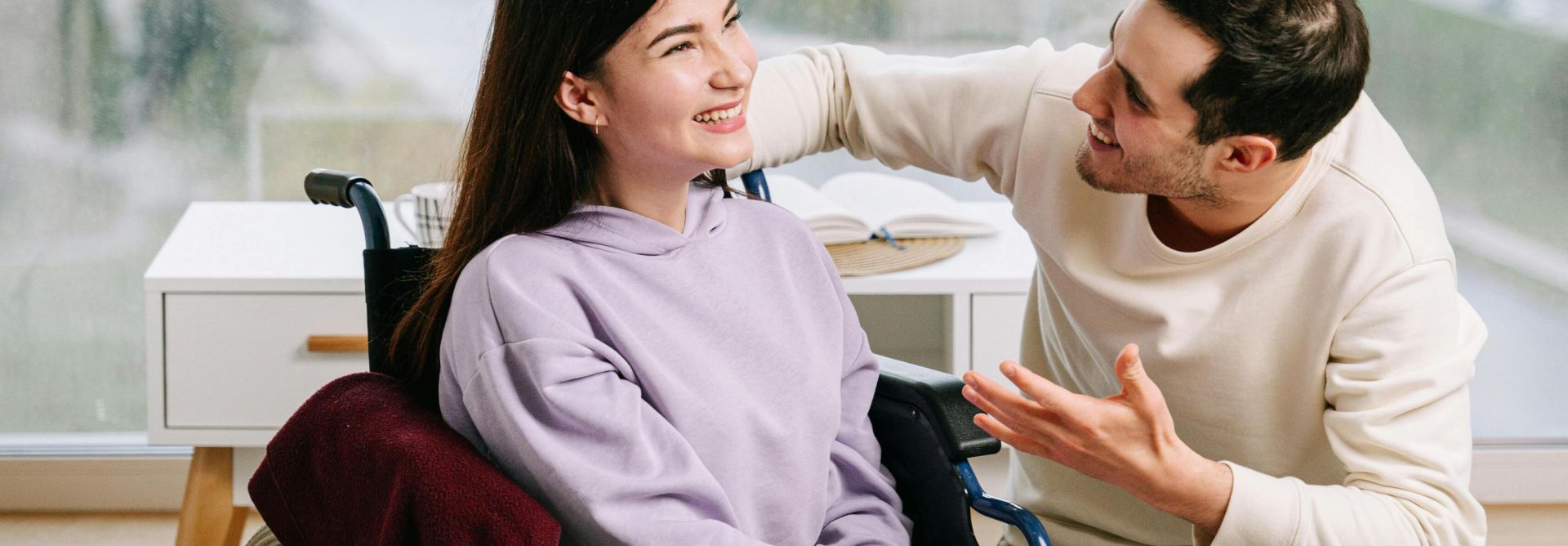 A loving couple shares a joyful moment in a bright indoor setting, embracing love and unity.